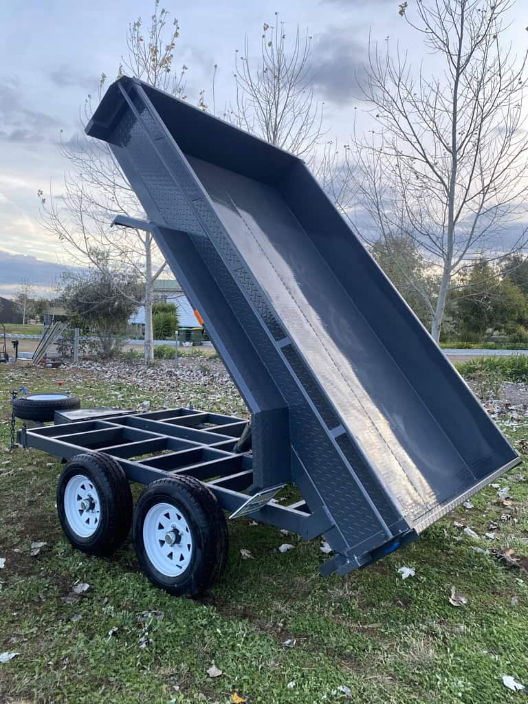 Tandem axle tipping trailer in yard